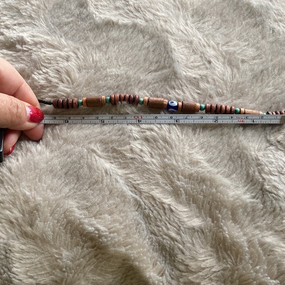 Bracelet with wooden beads and an evil eye bead in the center - Picture 3 of 3